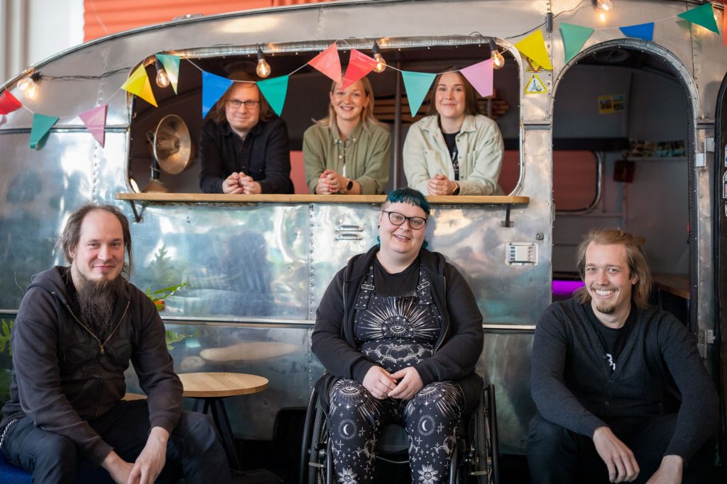 A group of people sitting and smiling at the camera.